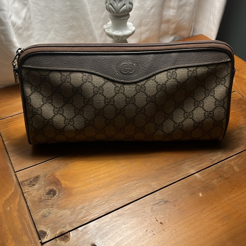 Gently used over size larger hand clutch. One zipper inside. No tips no stains.